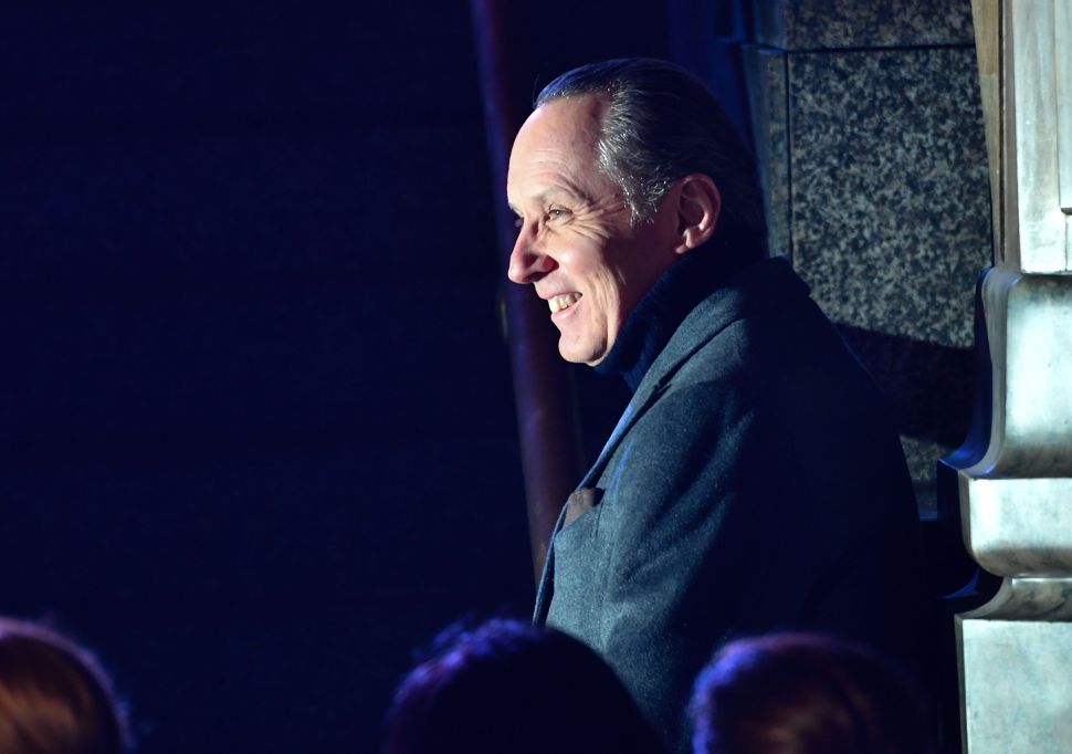 A profile of Ermenegildo "Gildo" Zegna walking onto a stage.