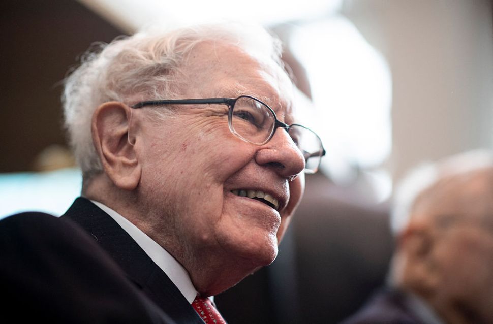 A close-up profile of a smiling Warren Buffett