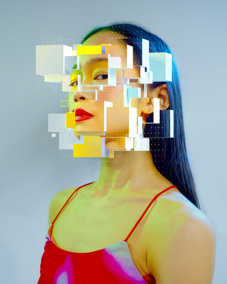 Digital generated image of young woman scattering into cubes