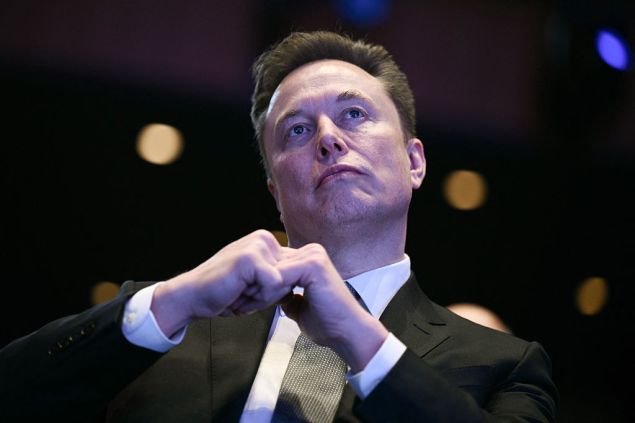 Elon Musk in a black suit