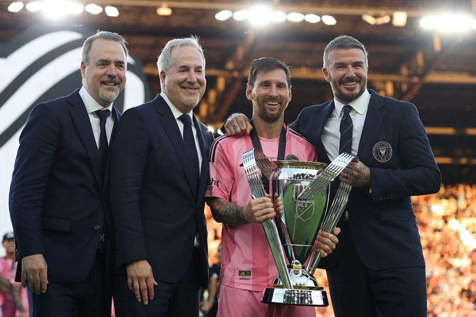 José Mas, Jorge Mas and Sir David Beckham, co-owners of Inter Miami CF pose with the Champion's trophy next to Lionel Messi #10 after winning the Audi 2025 MLS Cup Final match between Inter Miami CF and Vancouver Whitecaps FC at Chase Stadium on December 06, 2025 in Fort Lauderdale, Florida. 