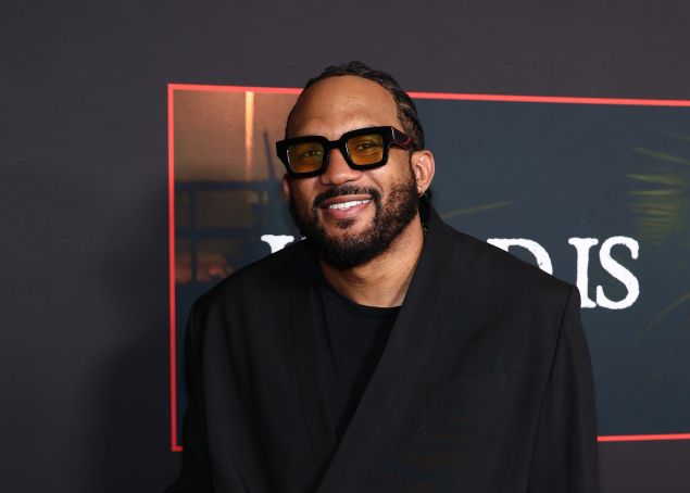 A Black man in an all-black outfit.
