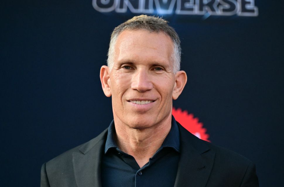 Man in suit poses on red carpet