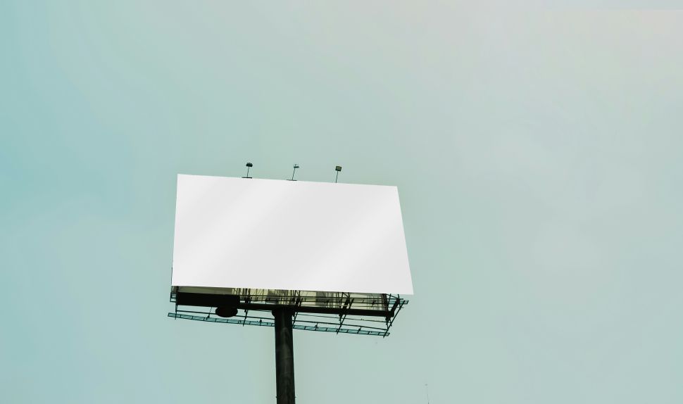 A blank billboard against a blue sky