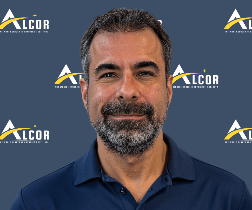 Headshot of man with beard wearing dark blue shirt